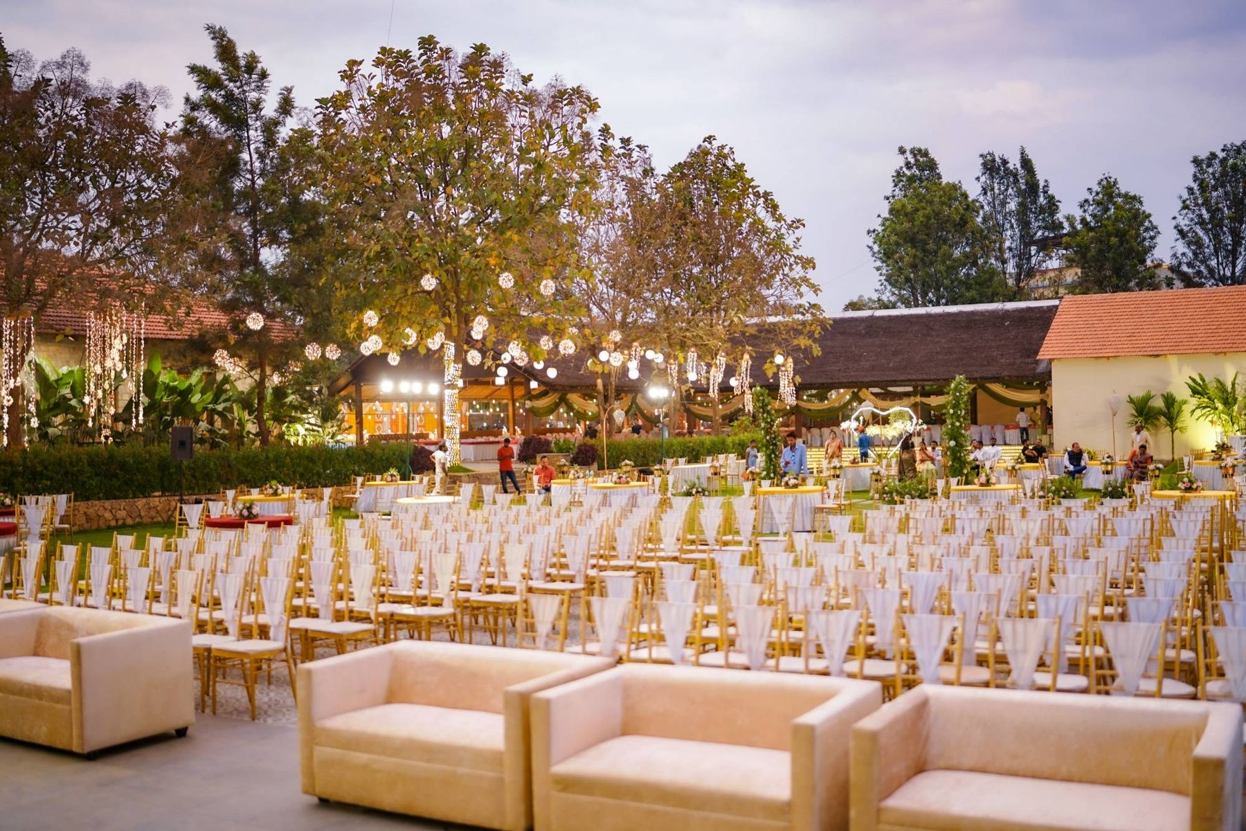 The lawn set for a reception at dusk